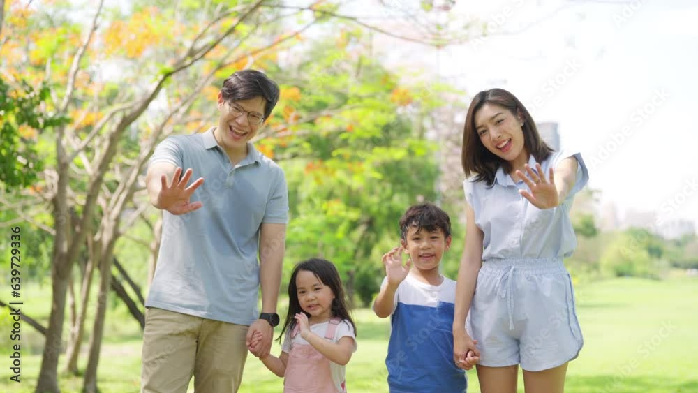 Happy Asian family spending time together travel on summer holiday vacation. Parents and little child enjoy and fun outdoor activity lifestyle walking and playing together at public park in the city. Happy Asian family spending time together travel on summer holiday vacation. Parents and little child enjoy and fun outdoor activity lifestyle walking and playing together at public park in the city.