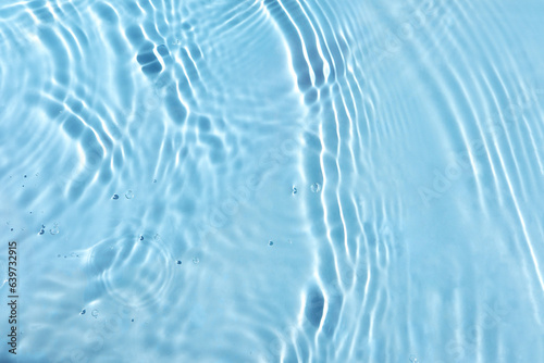 Texture of water surface reflections. Blurred transparent blue colored clear calm water surface texture with splash and bubbles. water waves with shining pattern texture background.