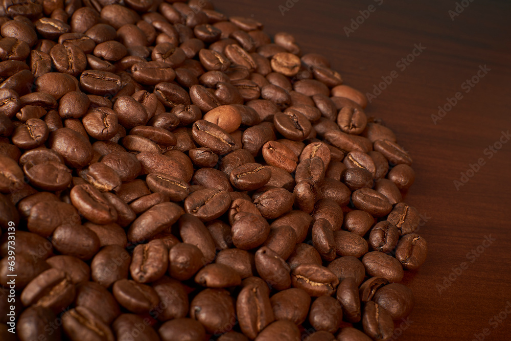 Fototapeta premium Aromatic Elegance: A close-up masterpiece capturing the intricate details of coffee beans on a rich wooden texture. The interplay of texture and aroma unfolds against a warm backdrop
