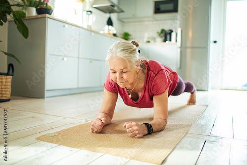Senior caucasian woman planking and exercising at home