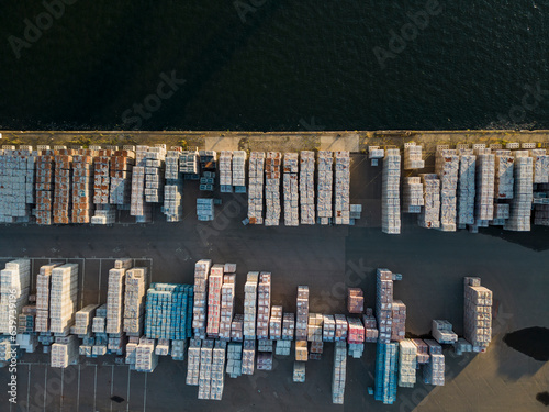 Aerial view of bricks on pallets at Tilbury Docks at the water edge