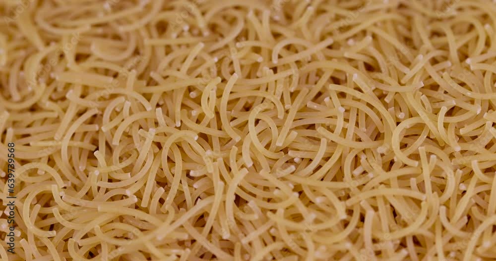 thin pasta made of high-quality wheat flour, uncooked pasta made of flour and water close-up thin pasta made of high-quality wheat flour, uncooked pasta made of flour and water close-up