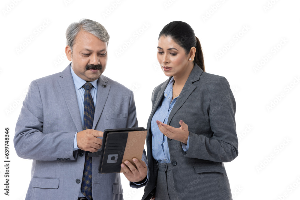 Studio shot of happy mature business colleagues using digital tablet over white background Studio shot of happy mature business colleagues using digital tablet over white background