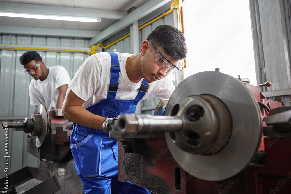 factory workers or technicians checking and control lathe machine in factory factory workers or technicians checking and control lathe machine in factory