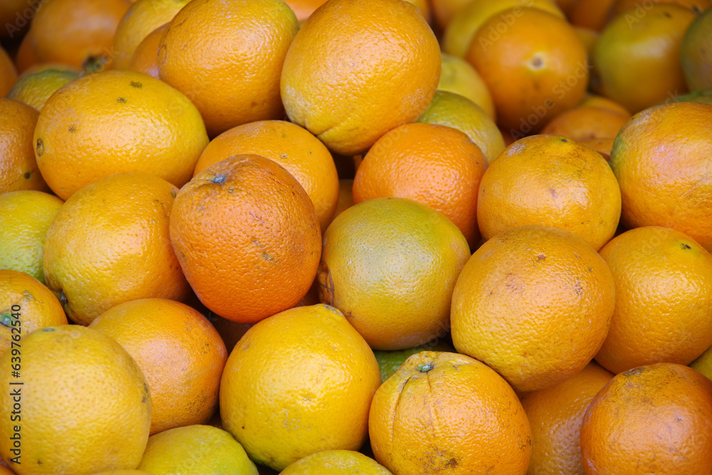 Oranges displayed at a market stand Oranges displayed at a market stand