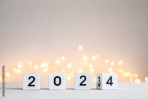 New Year 2024 coming. Numbers on wooden block cubes rotating from 2023 to 2024