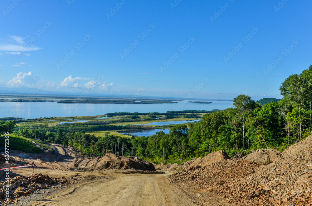 dirt road in taiga with Amur river scenic view near Malmyzh (Nanaysky district, Khabarovsk krai, Russia)