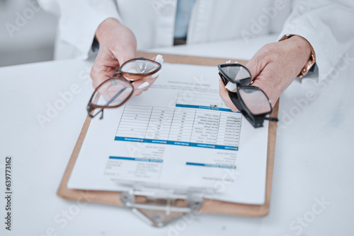 Clipboard, optometry and glasses for vision and eye care or wellness in an optical clinic. Checklist, medical and closeup of prescription spectacles with lens for optometrist or oculist treatment. photo