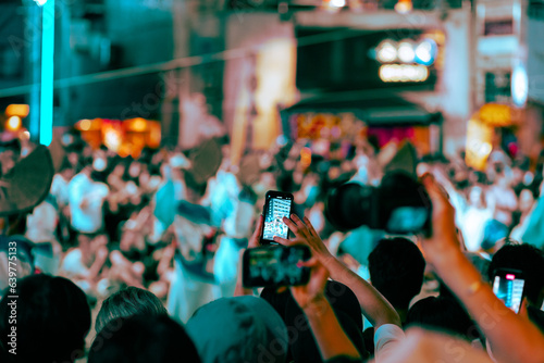 The person filming the festival with his cell phone