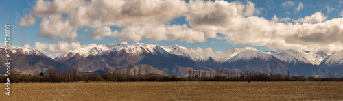 The snow capped mountain range called Ben Ohau on the rural countryside at Twizel photo