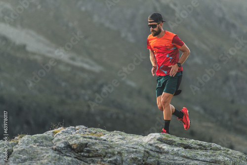 Photography An athlete runs over boulders in the mountains