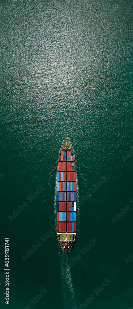aerial top view of cargo container ship carrying in green sea import export goods and distributing products to dealer consumers, global business transportation by container ship open sea,