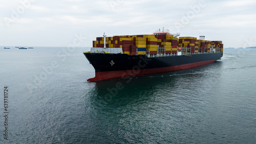 aerial front view cargo container ship carrying in sea import export goods and distributing products to dealer consumers, global business transportation by container ship open sea,