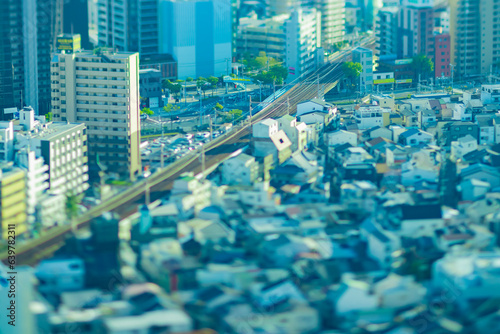 A dusk miniature cityscape by high angle view near the railway in Osaka 