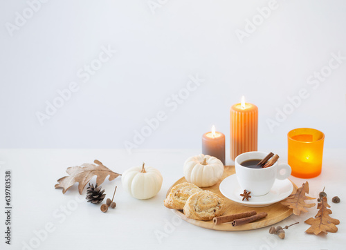 white cup of coffee with cozy decor on white table
