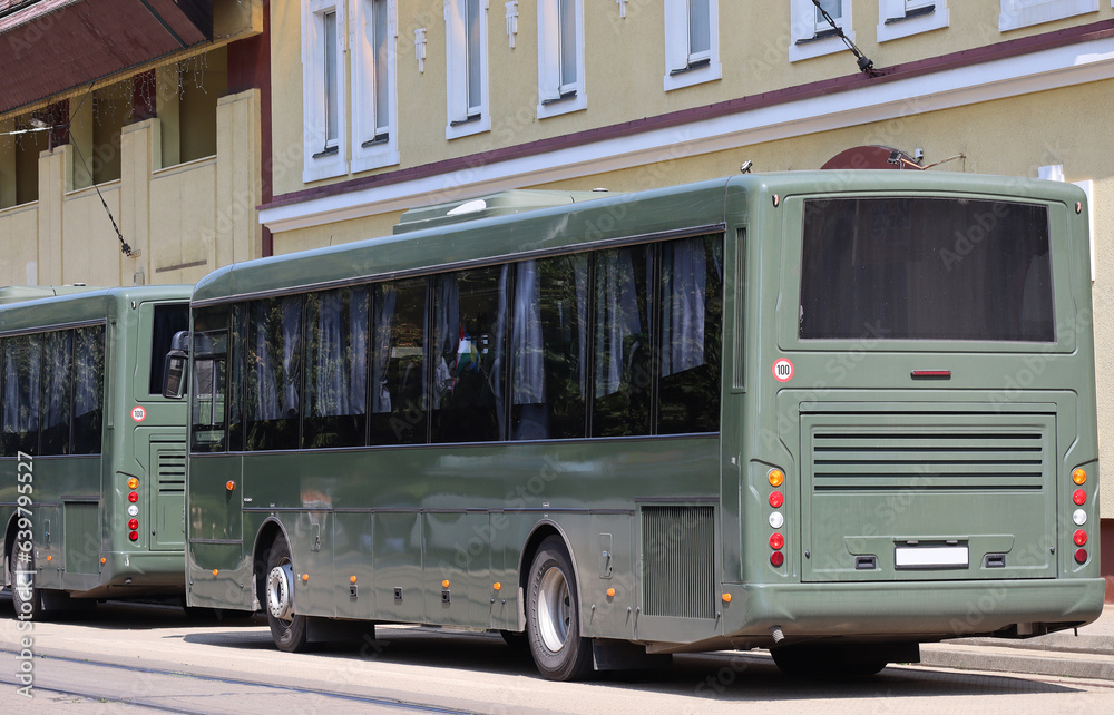 Green colored military buses on the street