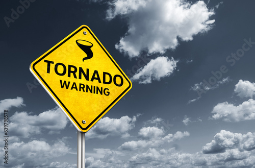 Fotografie, Obraz Tornado warning - message on yellow road sign