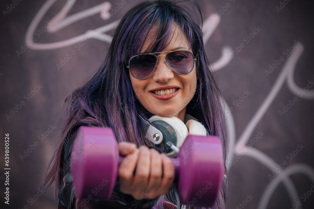 young woman with headphones and dumbbells young woman with headphones and dumbbells