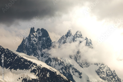Mountains illuminated by sun breaking through the clouds © Tristan