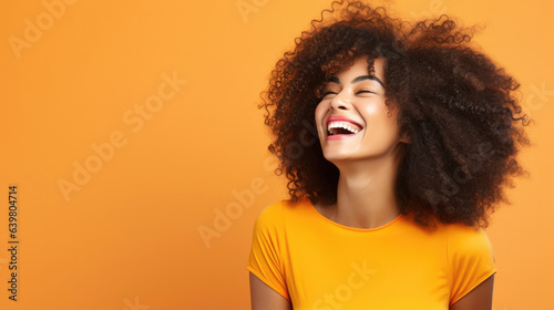Beautiful woman with afro hair smiling on bright background, smiling portrait