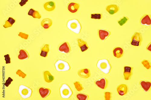Fototapeta Naklejka Na Ścianę i Meble -  Assorted gummy candies. Top view, Jelly sweets isolated on yellow background