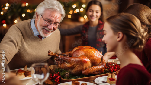 Grandfather cutting turkey for family on thanksgiving dinner