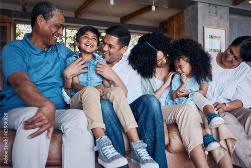 Laughing, big family and on a home sofa for conversation, visit or bonding. Happy, together and parents, children and grandparents on a couch for a joke, comedy or communication in the living room