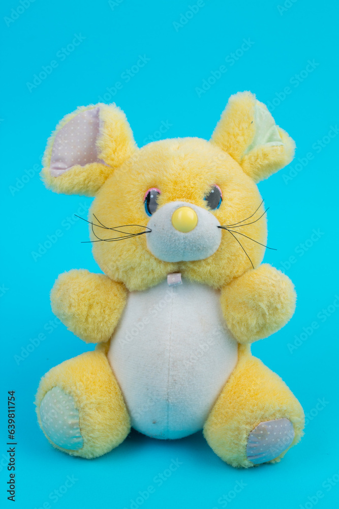 Pluche toy mouse on a blue background. Pluche toy mouse on a blue background.