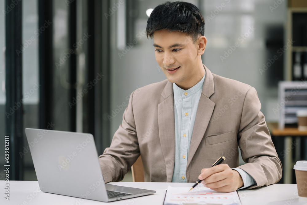 Business man working at office with laptop and documents on desk, financial adviser analyzing data. Business man working at office with laptop and documents on desk, financial adviser analyzing data.