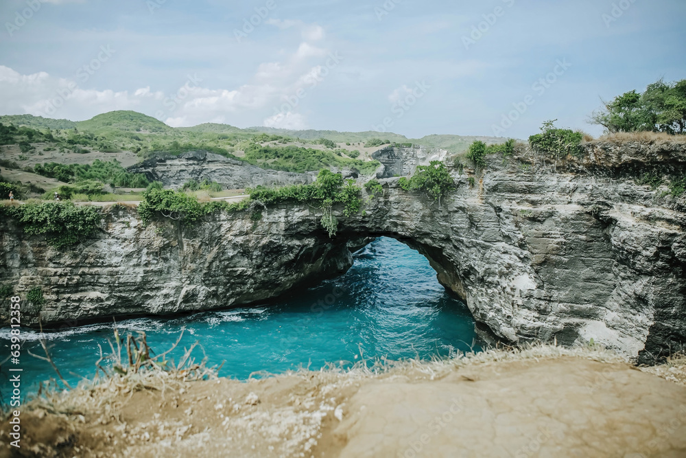 Karang Bolong beach with clear blue water and sky located in Nusa Penida, Bali, Indonesia. Selective focus.