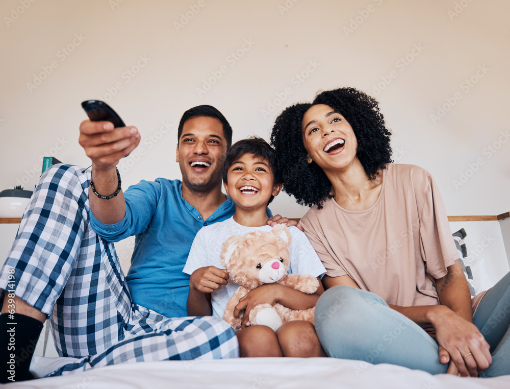 Smile, morning and family watching tv in a bedroom of their home together for streaming or entertainment. Parents, children or a boy laughing on the bed with his mother and father to enjoy television