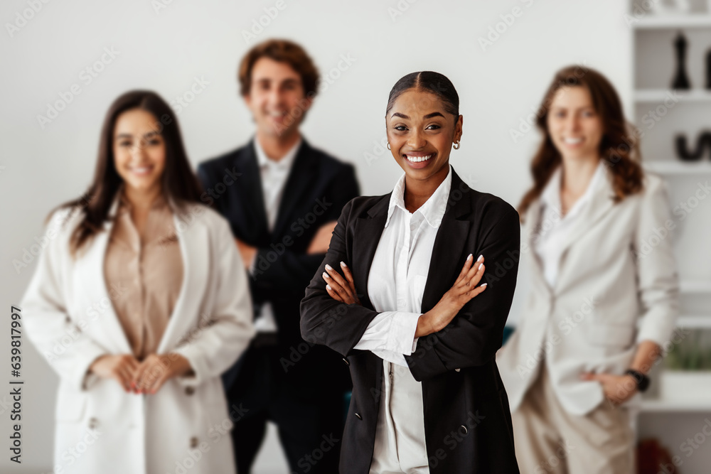 Diversity and business team portrait. Business people posing in office interior and smiling at camera Diversity and business team portrait. Business people posing in office interior and smiling at camera