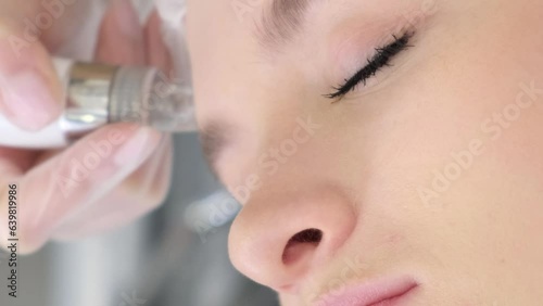 Close-up of a woman receiving a hydromicrodermabrasion facial peel at a cosmetic spa clinic. photo