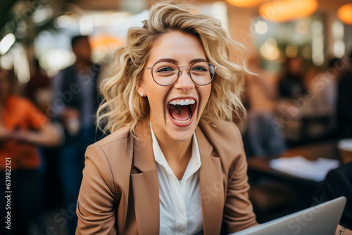 Blonde enthusiastic businesswoman screaming with joy and success
