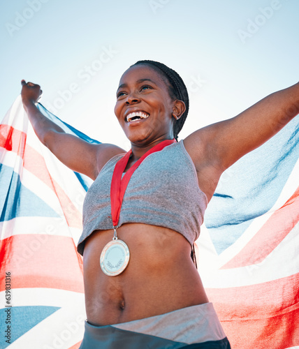 Fitness, winning and black woman with achievement, UK flag and sports with competition, victory and champion. African person, athlete or winner with British symbol, pride and medal with celebration