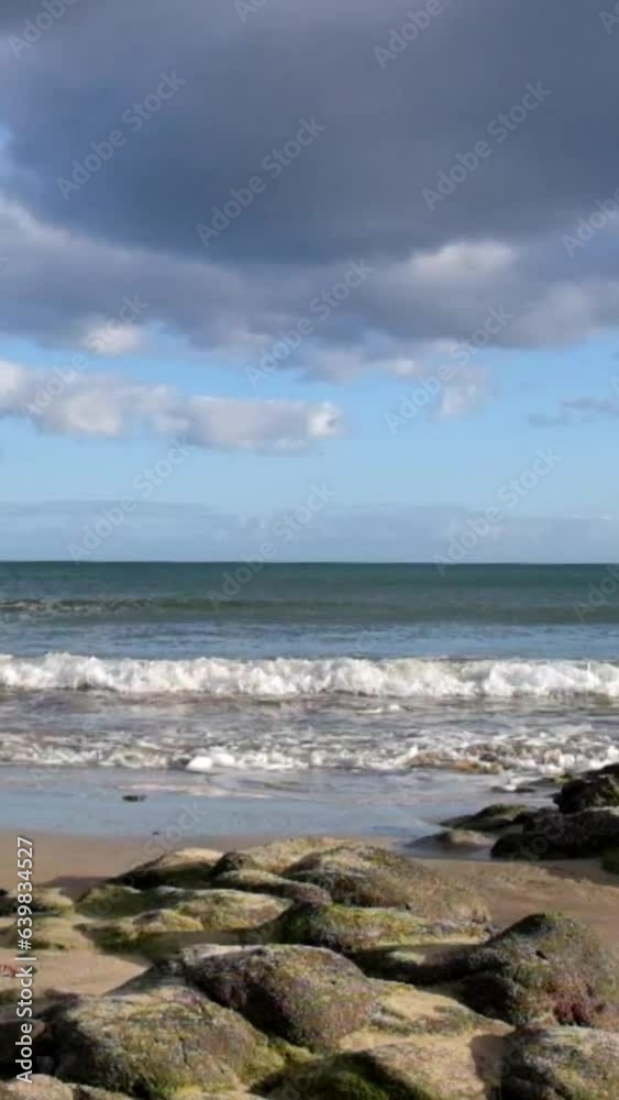 Sea surf on a sandy beach with stones in the morning Sea surf on a sandy beach with stones in the morning