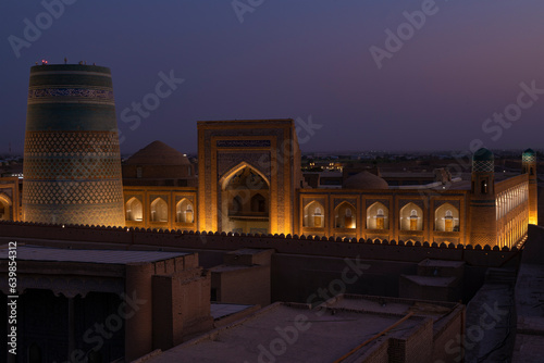 The ancient madrasah of Muhammad Amin Khan and the Kalta Minor minaret on a September evening. The inner city of Ichan-Kala, Khiva photo