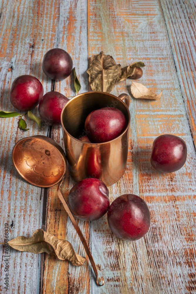 A still life with ripe red plum prunus