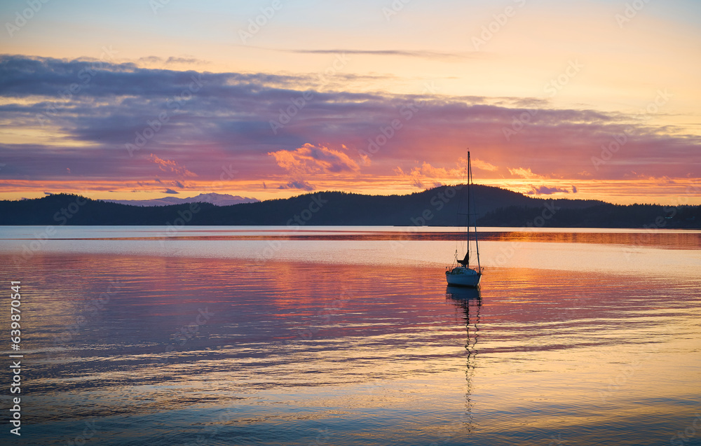 sailboat in Halfmoon Bay. sunset over the sea. Sunshine Coast, British Columbia, Canada