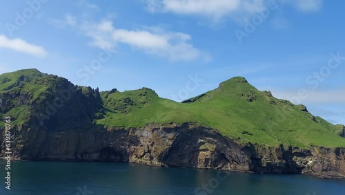 Tranquil island in Vestmannaeyjar archipelago with stunning coastal landscapes and serene atmosphere.