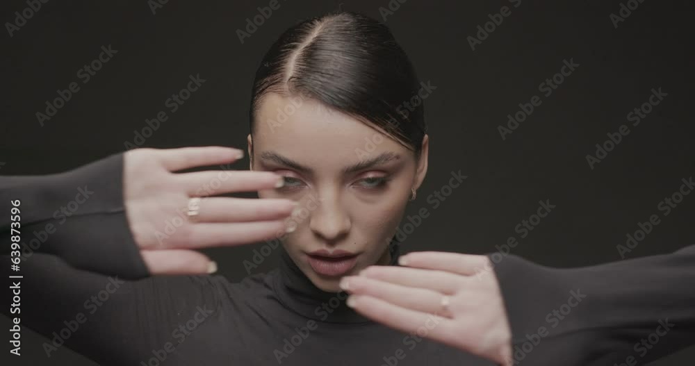 Portrait shooting of a young woman in a studio on a black background Portrait shooting of a young woman in a studio on a black background