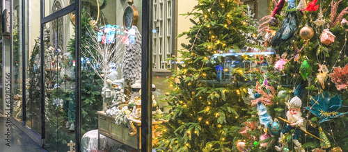 Christmas shop window decorated with christmas gift Beautiful festive Christmas storefront with decorated artificial Christmas trees and toys