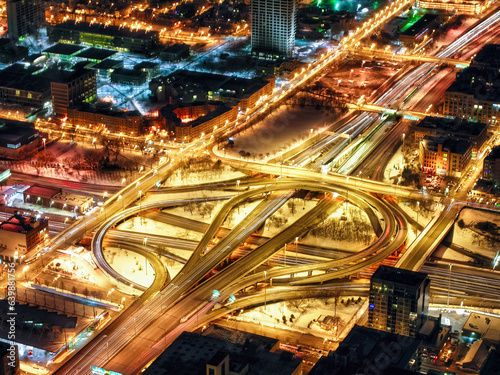 Long exposure, night time aerial view of the Jane M. Byne Interchange in Chicago, Illinois. The interchange is a major transportation hub, and it connects several major highways.