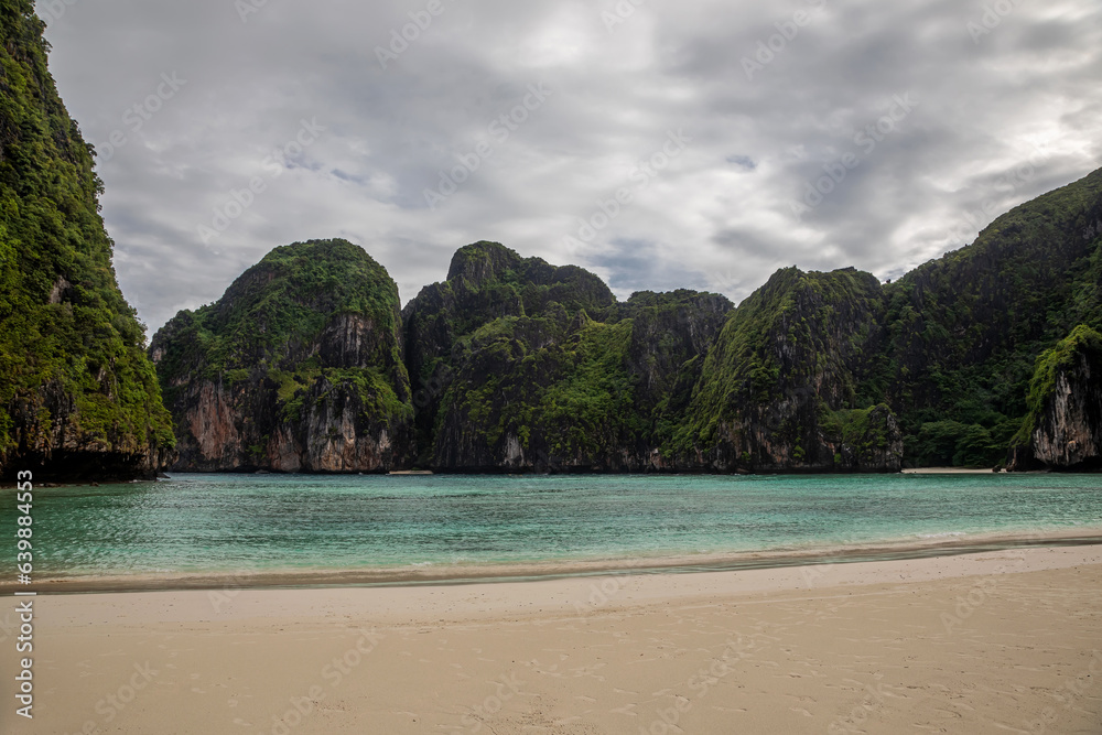 Fototapeta premium Beautiful and empty beach. Sea and high rocks. The famous Maya Bai. Sunny morning. Colorful sea.