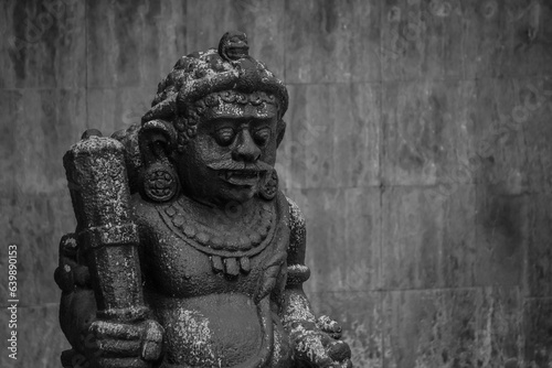 Dwarapala is traditional Javanese guardian statues holding a large mace in the form of gods  people or demons. Indonesian sculpture made of stone carvings in temple or shrine sacred place gate.