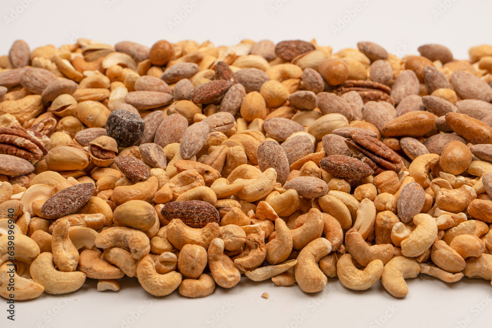 A group of almonds, pistachios, walnuts, macadamia, cashews. A group of almonds, pistachios, walnuts, macadamia, cashews.