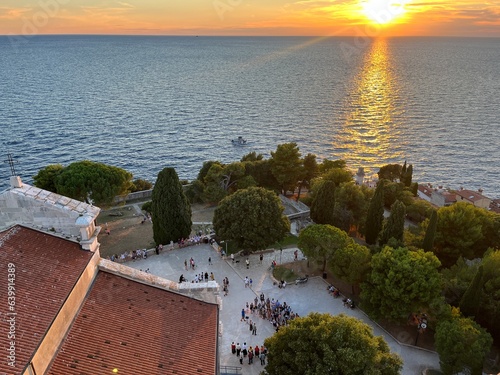 Stunning sunset over the Adriatic Sea, viewed from the bell tower of the Church of Saint Euphemia in the pristinely preserved old Istrian town of Rovinj, Croatia photo