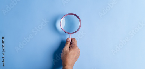 searching, securing, magnifier, icon, man, hand, blue, assurance, family, background. hold a magnifier to searching or find something at blue background. not has icon and symbolic isn't show.