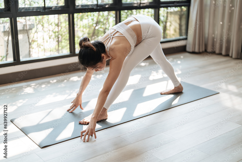 Fitness asian woman doing yoga stretching exercise on mat yoga fitness exercises. Healthy lifestyle Calmness and relax at yoga studio Fitness asian woman doing yoga stretching exercise on mat yoga fitness exercises. Healthy lifestyle Calmness and relax at yoga studio