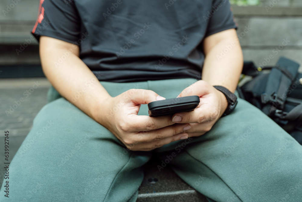 Man playing game on mobile phone. gamer boy playing video games holding Smartphone working mobile devices. cell telephone technology e-commerce concept Man playing game on mobile phone. gamer boy playing video games holding Smartphone working mobile devices. cell telephone technology e-commerce concept